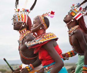 Marcy Mendelson, The Samburu Story | A dance called the 'maasani', the moran and women hold hands and dance together. Outside Kisima, Samburu County, Kenya. August 22, 2013.