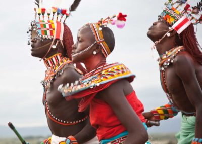 Marcy Mendelson, The Samburu Story | A dance called the 'maasani', the moran and women hold hands and dance together.  Outside Kisima, Samburu County, Kenya.  August 22, 2013.