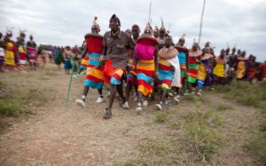 Marcy Mendelson, The Samburu Story | Morans & young women celebrate with dancing and singing into the night. Pictured here is the partner dance called Maasani.
