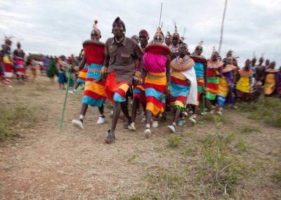 Marcy Mendelson, The Samburu Story | Morans & young women celebrate with dancing and singing into the night.  Pictured here is the partner dance called Maasani.