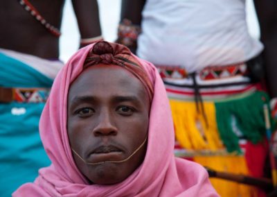 Marcy Mendelson, The Samburu Story | Samburu moran (warriors) celebrate their graduation into 'senior' moran status of the Loimisi clan.  Outside Kisima village, Samburu, Kenya.