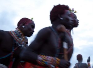 Marcy Mendelson, The Samburu Story | Samburu moran (warriors) celebrate their graduation into senior status with singing and dancing through the night. Outside Kisima village, Samburu, Kenya. August 22, 2013.