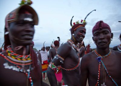 Marcy Mendelson, The Samburu Story | Samburu moran (warriors) in a celebratory mood following their graduation ceremony into senior warrior status.  Outside Kisima village, Samburu, Kenya.  August 22, 2013.